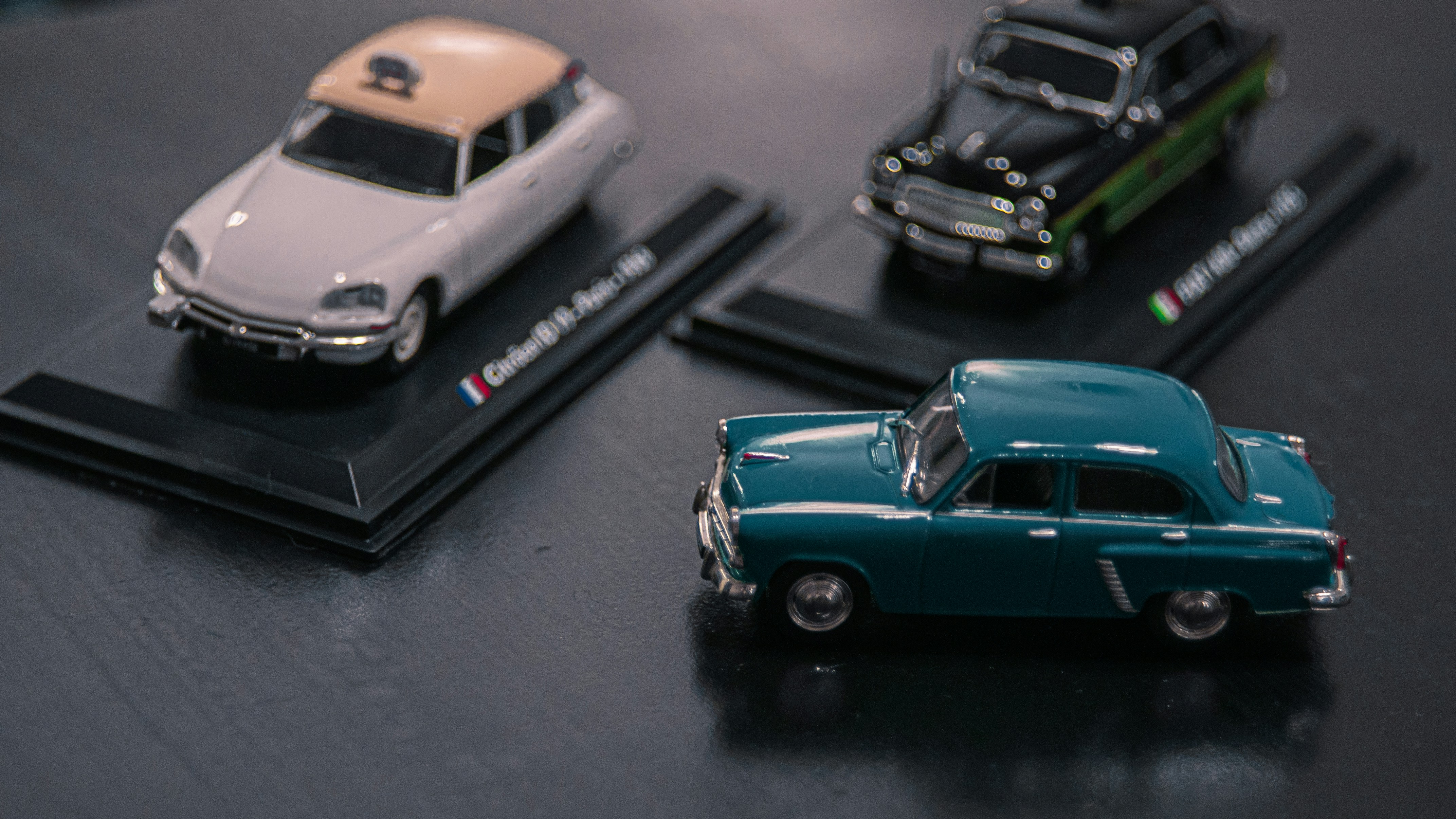 Fashion model in flowing black dress walking on cobblestone street - editorial fashion ecommerce hero lookbook photo